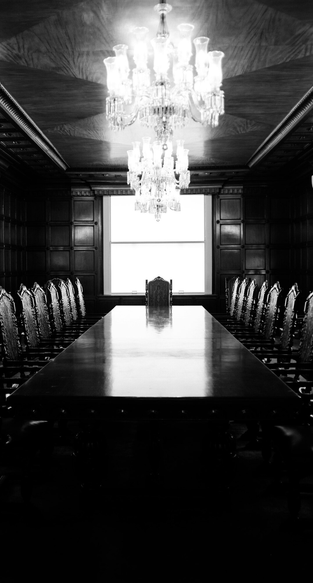 Executives in a glass boardroom discussing strategy
