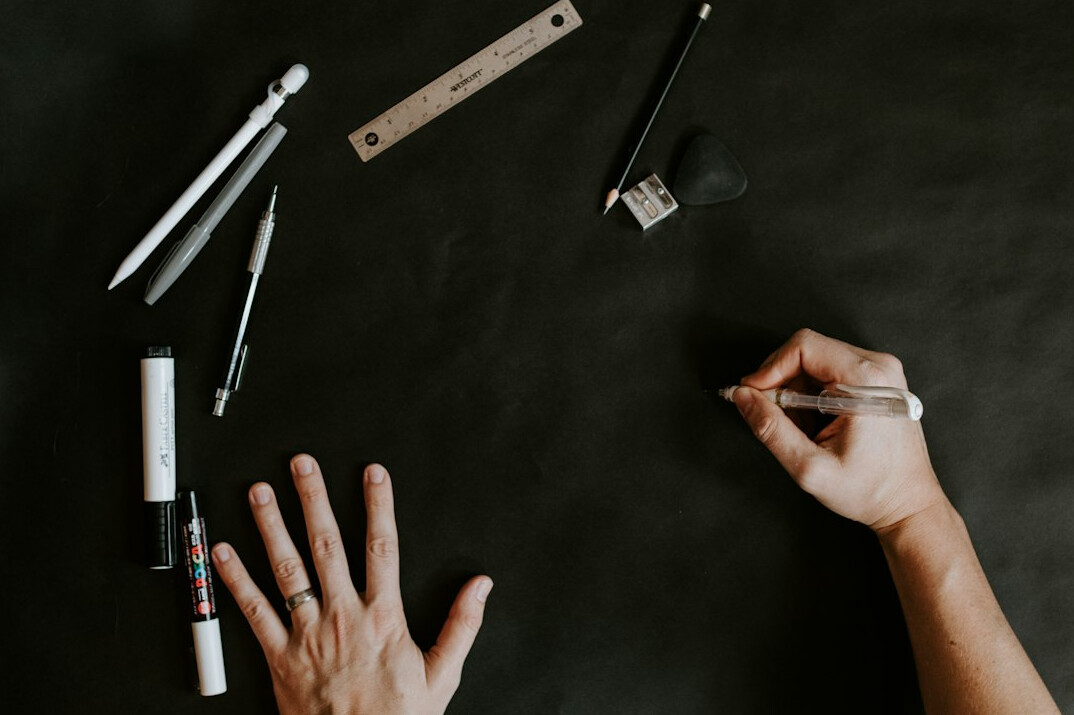 Close-up of hands analyzing printed charts and graphs